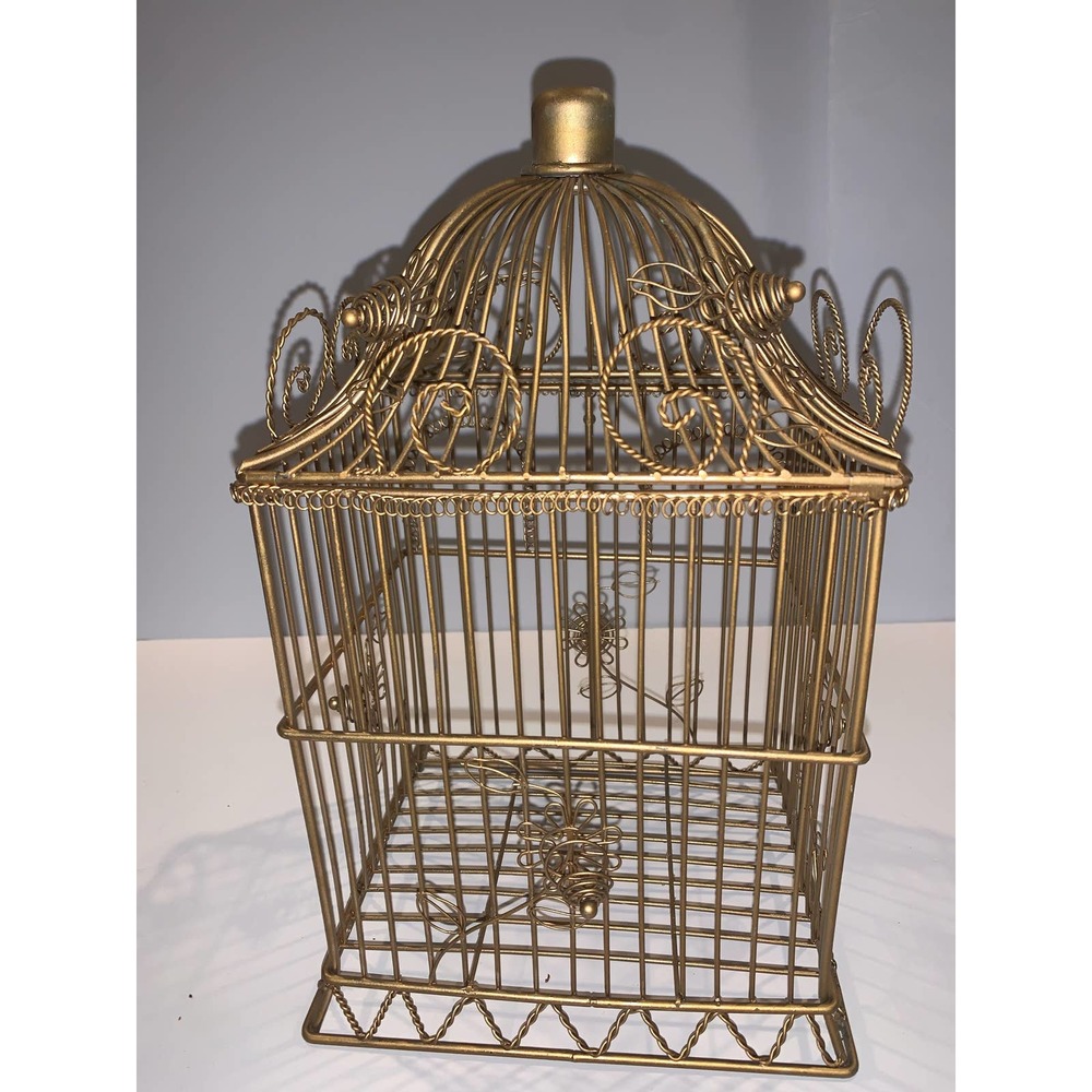Gold tone wore birdhouse that opens from the top